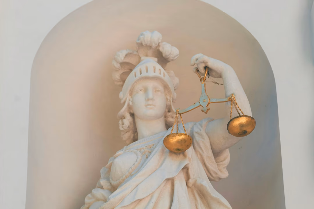 手持天秤的正義女神雕像，象徵監管審查與訴訟對 AI 公司估值的影響
