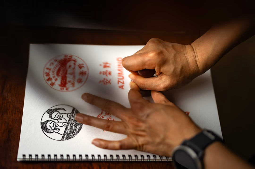 在文件上蓋下紅色與黑色印章的手部特寫，象徵產證與押匯文件每一次用印都應留下可追溯的紀錄